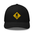 Bigfoot crossing sign embroidered black trucker hat front view – funny outdoor hiking cap