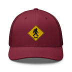 Bigfoot crossing sign embroidered cranberry trucker hat front view – funny outdoor gift hat