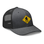 Dark gray heather Bigfoot crossing sign trucker hat side view – funny embroidered Sasquatch cap