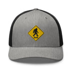 Bigfoot crossing sign embroidered gray heather trucker hat black mesh front view – funny outdoor cap