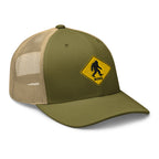 Moss and khaki mesh Bigfoot crossing sign trucker hat side view – funny Sasquatch cap for hikers